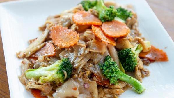 Pad See-Ew · Stir-fried wide rice noodles in black bean sauce with eggs, broccoli, carrots, and choice of meat.
