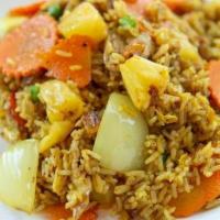 Pineapple Fried Rice · A fabulous dish of fried rice with curry powder, raisins, pineapple, peas, onions, and carro...
