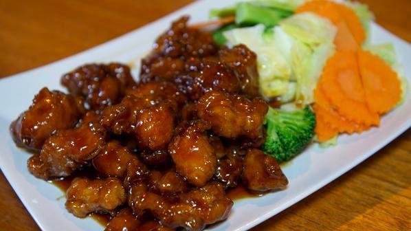 Crispy Orange Chicken · Crispy-fried chicken in house special orange sauce, serve with steamed broccoli, carrots, and cabbage.