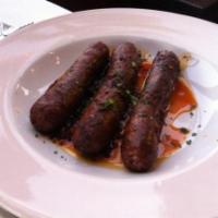 Merguez a la Harissa · Spicy Moroccan lamb sausages. Spicy.