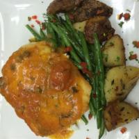 Baked Chilean Sea Bass Provencal · Served with petit legumes, fingerling potatoes and lemon butter tomato capers sauce.
