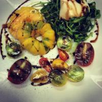 Heirloom Caprese Salad Brunch · Organic Heirloom tomatoes, fresh burrata cheese, basil oil, and aged balsamic vinegar. Veget...