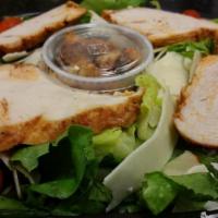Chicken Caesar Salad · Fresh chicken breast on a bed of romaine lettuce, Parmesan cheese and homemade croutons. Ser...
