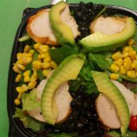 Southwest Chicken Salad · Chicken breast, black bean, sweet corn, avocado and tomato over mixed greens. Served with ch...