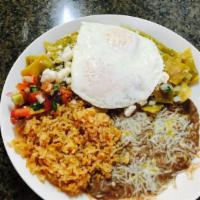 Chilaquiles · Choice of red or green sauce topped with onions, cheese, and two eggs. 
Served with rice, be...