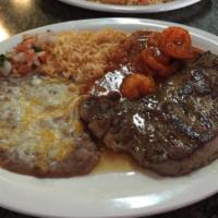 New York Steak · Served with rice and beans.