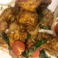 48. Drunken Noodle Tofu · Tofu sauteed with wide rice noodles, tomato, basil leaves, sweet peppers, onions and chili s...