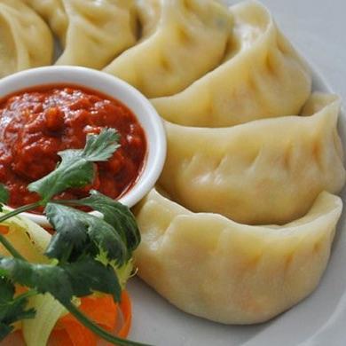 Vegetable Momo · A traditional delicacy of Nepal these vegan appetizers are a type of steamed dumplings consisting of a well-seasoned vegetable filling. (VG)
