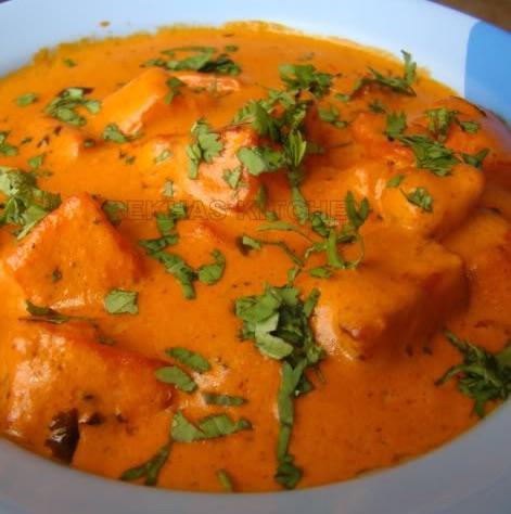 Paneer Makhani · A blend of yogurt, spices marinated paneer dressed in a velvety red bath composed of a butter sauce cooked with garam masala. (GF)
