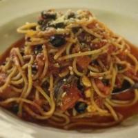 Puttanesca · Cooked with garlic, anchovies, capers, olives, white wine in a spicy marinara and diced toma...