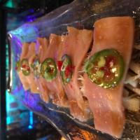 Yellowtail Jalapeno · Thinly sliced yellow tail dressed with yuzu soy, garlic puree, jalapeno on top. Hot and spicy.