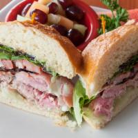 Seared Ahi Tuna Sandwich · Baby field greens, plum tomatoes, pink ginger, wasabi aioli and sliced cucumber. Served with...
