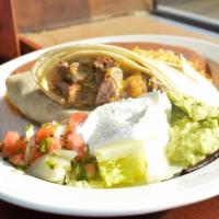 Burrito de Bistec con Arroz y Frijoles · Steak burrito with rice and beans. Sauteed with onions, tomatoes, cheese and salsa in a flou...