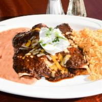 Enchiladas de Pollo en Mole Poblano Entree · 3 soft corn tortillas, filled with chicken, baked and topped with special mole sauce and gra...