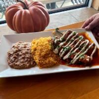 Chiles Rellenos pollo · 2 toasted poblano peppers stuffed with chicken and cheese, served in a light tomato sauce wi...