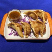 Gyoza Dumpling · Diced vegetables mixed with pork, pan fried then steamed or deep fried.