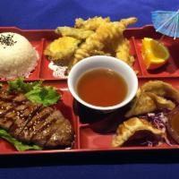 Hyuga Steak Box · Charbroiled New York steak with assorted tempura and gyoza. Served with miso, rice, salad an...