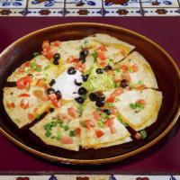 Quesadilla · Two flour tortillas, one on top of the other filled with cheese. Topped with green onions, t...