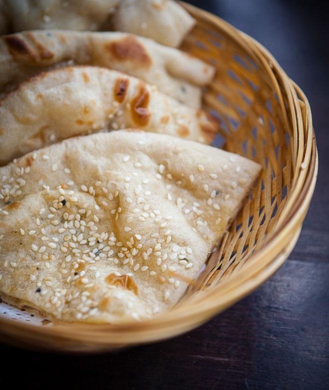 49. Butter Naan · Soft flour bread with butter and sesame seeds (clay oven).