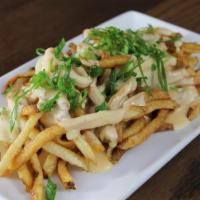 Cheeseheads Spud Topper · Fries covered with melted Wisconsin cheddar and green onions.