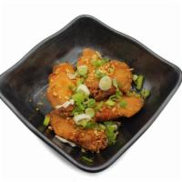 Chicken Wings · Housemade crispy marinated chicken wings topped with a citrusy garlic glazed.