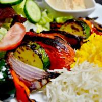 Veggie Kebab · Grilled zucchini, eggplant, bell pepper, onion and tomato. Served with rice, garden salad, h...