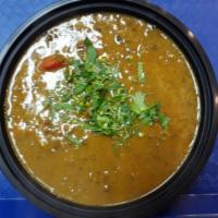 Dal Tarka · Black lentils cooked to perfection with onion and tomato, herbs and spices. Vegetarian.
