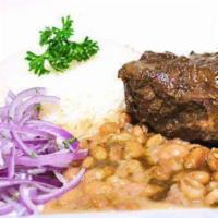 SECO A LA NORTENA · Beef marinated in cilantro sauce served with canary beans and rice. 