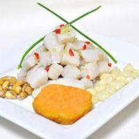 CEVICHE DE PESCADO · Raw fish marinated in lime juice with garlic, celery, onions and rocoto chili, served with s...