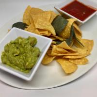 Housemade Guacamole and Chips · Freshly mashed Hass avocado guacamole, hand cut pico de gallo with warm white and blue corn ...
