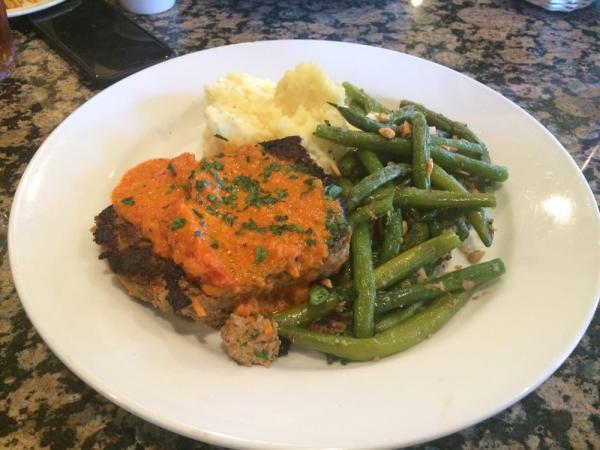 Shelton Farms Turkey Meatloaf · Naturally raised turkey with chopped baby spinach, carrots, and onions, slow-baked and served with Yukon gold mashed potatoes, rich sun-dried tomato gravy, and green beans with slivered almonds.