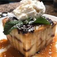 Warm Bread Pudding · Vanilla and brandy flavored with raisins and warm caramel sauce, topped with vanilla bean ic...