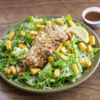 Chicken Caesar Salad · Grilled or crispy chicken, Parmesan, croutons and lemon with Caesar dressing.