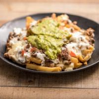 Carne Asada Fries · French fries topped with refried beans, melted cheese, jalapenos, guacamole, pico de gallo a...