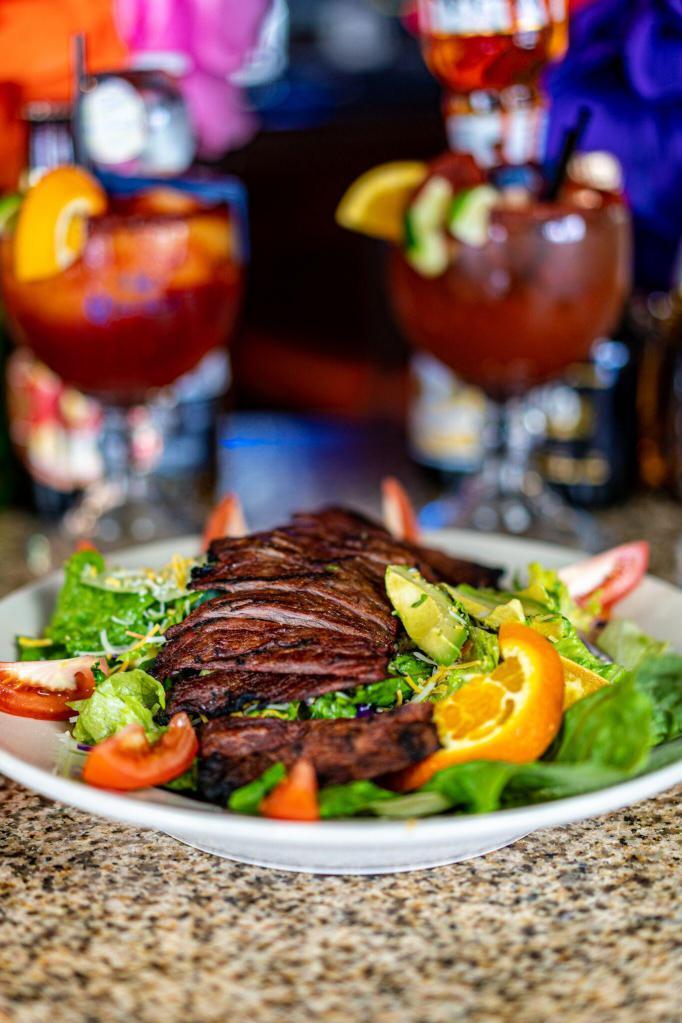Steak Salad · Includes mixed greens, carrots, cucumber, zucchini, cabbage, cheese, tomatoes and avocado