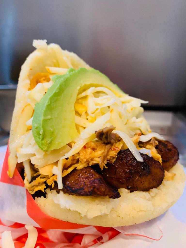 Arepa Burger · Shredded beef, chicken, black beans, sweet plantain, white  cheese and avocado.