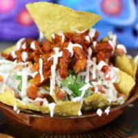 Nachos · Topped with black bean sauce, jalapenos, tomatoes, onions, cream cheese and choice of meat.
