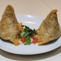 2 Piece Vegetable Samosa · Triangular shaped crispy turnovers filled with potatoes, peas and vegetables. Vegetarian.