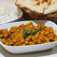 Aloo Chole · Chickpeas slowly simmered and cooked with potatoes, onions, tomatoes and house spices. Glute...
