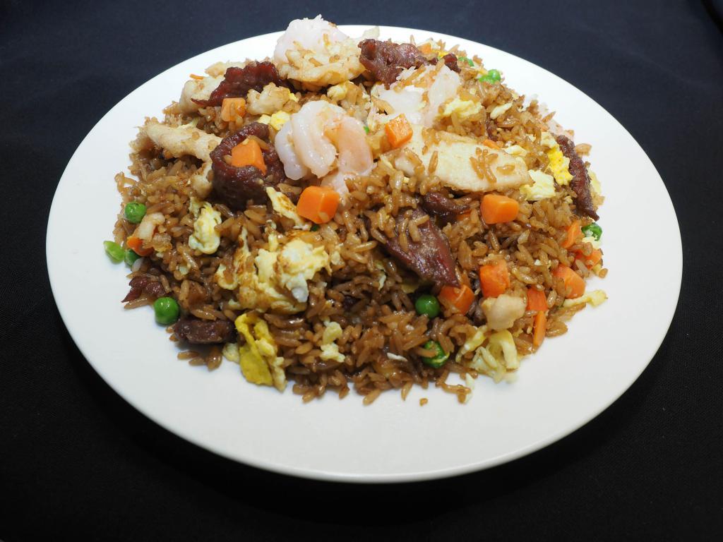 House Fried Rice · Tender chicken, flank steak beef, jumbo shrimp, eggs, peas, and carrots with soy sauce based seasoning.