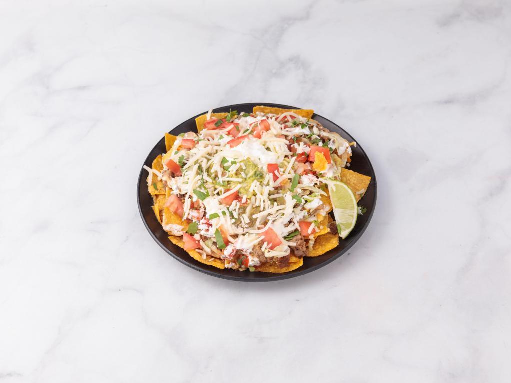 Nachos · Served with your choice of meat, lettuce, guacamole, sour cream, cheese, beans and pico de gallo.
