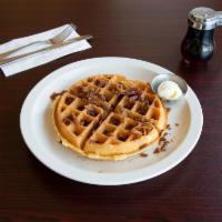 Bacon Waffle · Belgian waffle filled and topped with real bacon bits. Served with whipped butter and hot sy...