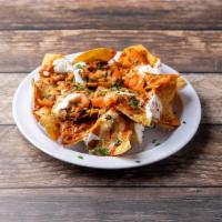 Nachos Grandes · Crispy tortilla chips with beans, ranchero sauce, melted cheese, sour cream and pico de gall...