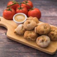 Garlic Knots · Six pieces. Knots of our homemade dough smeared with our garlic butter sauce and sprinkled w...