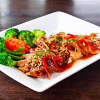 Duck Num Dang · Crispy duck with sweet and sour wine sauce served with steamed vegetables.