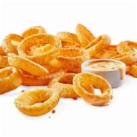 Beer-Battered Onion Rings Basket · Dunked in beer batter then fried to a golden crisp, these thick-cut onion rings are served w...