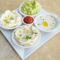 Mixed Dips Plate · Hummus, labaneh, tahini and avocado salad. Served with toasted pita bread.