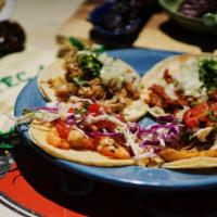 Street Tacos · Organic corn tortillas, choice of meat, topped with cilantro and onions.