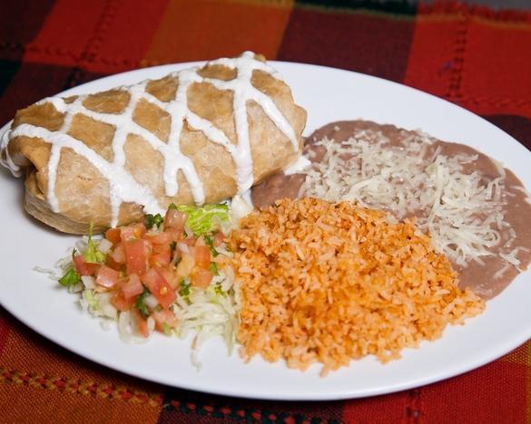 Chimichanga · Deep fried burrito stuffed with choice of meat and cheese. Tomato rice, beans, sour cream, guacamole and salsa on the side.