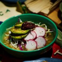Green Pozole Soup with Hominy · Chunks of pork and spine meat with hominy. Choice of tortillas. Onion, cilantro & lime on th...